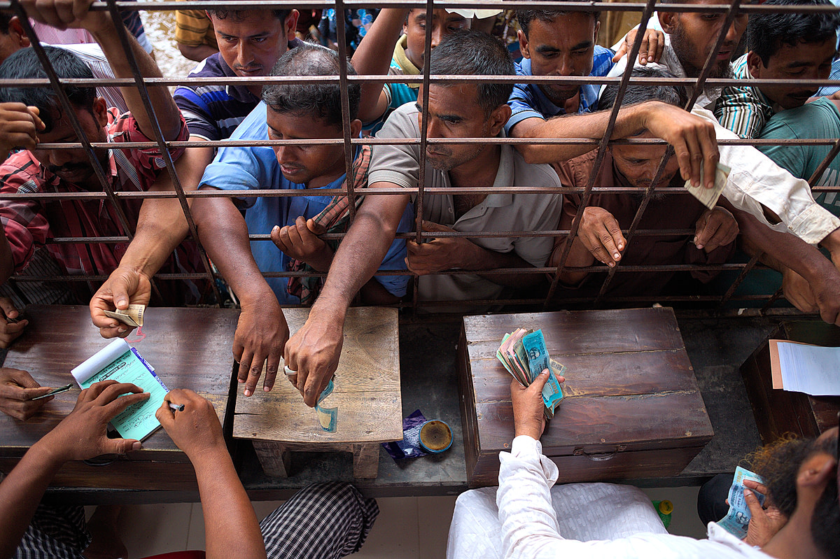 At the cash desks of Bagachra in southwest Bangladesh money frantically changes hands. Each purchase has to be documented by the local authorities and confirmed with a receipt. For this authentification buyers pay approximately 500 Taka (5,75?) and are then the official owner of the cow in Bangladesh, 2015. Christian Faesecke / We Animals