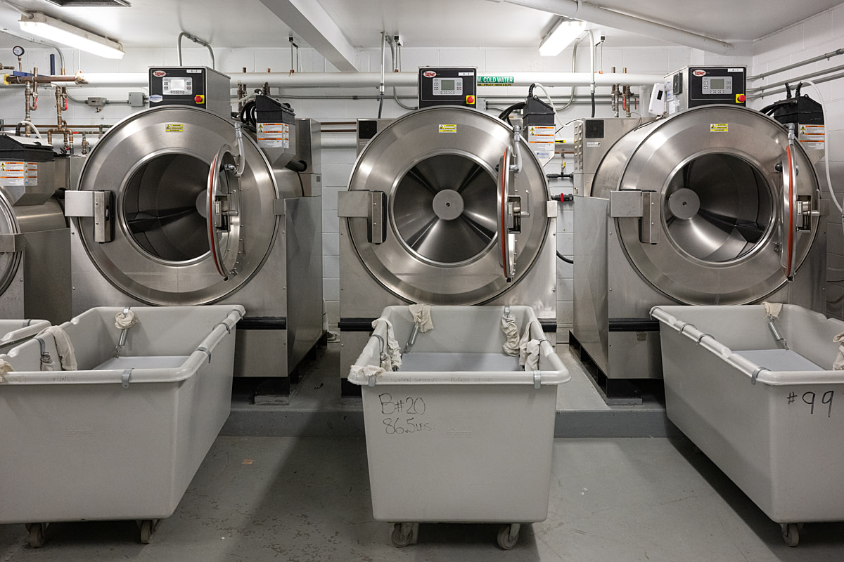 A building formerly labelled "Pen Farm" was converted into a laundry following the 2011 closure of Canada's prison farms. The high volume of water consumed by dairy cows made the infrastructure conversion easy, and the laundry is expected to be more profitable than the former dairy, which operated at a loss. Collins Bay Institution, Kingston, Ontario, Canada, 2025. Jo-Anne McArthur / We Animals A building formerly labelled "Pen Farm" was converted into a laundry following the 2011 closure of Canada's prison farms. The high volume of water consumed by dairy cows made the infrastructure conversion easy, and the laundry is expected to be more profitable than the former dairy, which operated at a loss. Collins Bay Institution, Kingston, Ontario, Canada, 2025. Jo-Anne McArthur / We Animals