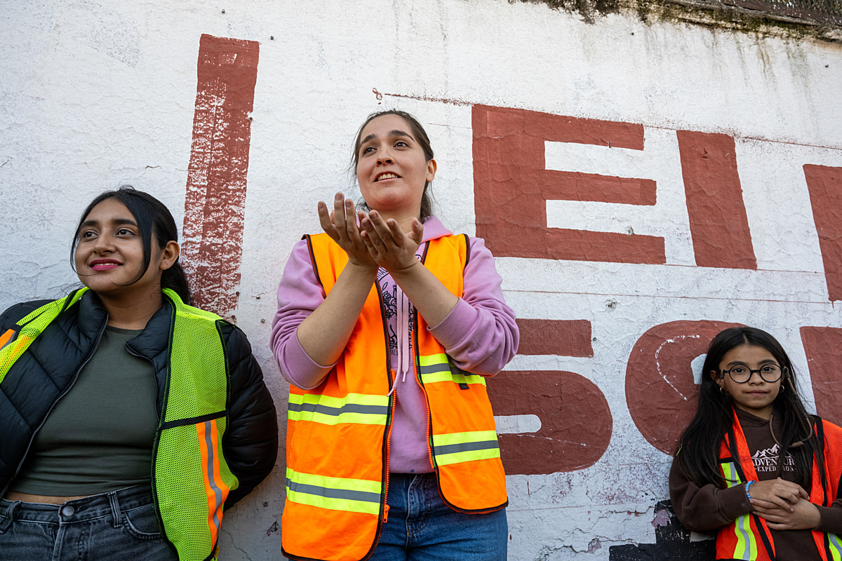 CDMX Animal Save Movement attendees debrief after attending a vigil at pig, cattle, and chicken slaughterhouses. Attendees were permitted to rescue a chicken from the chicken slaughter facility during the vigil. Mexico City, Mexico, 2025. Jo-Anne McArthur / We Animals
