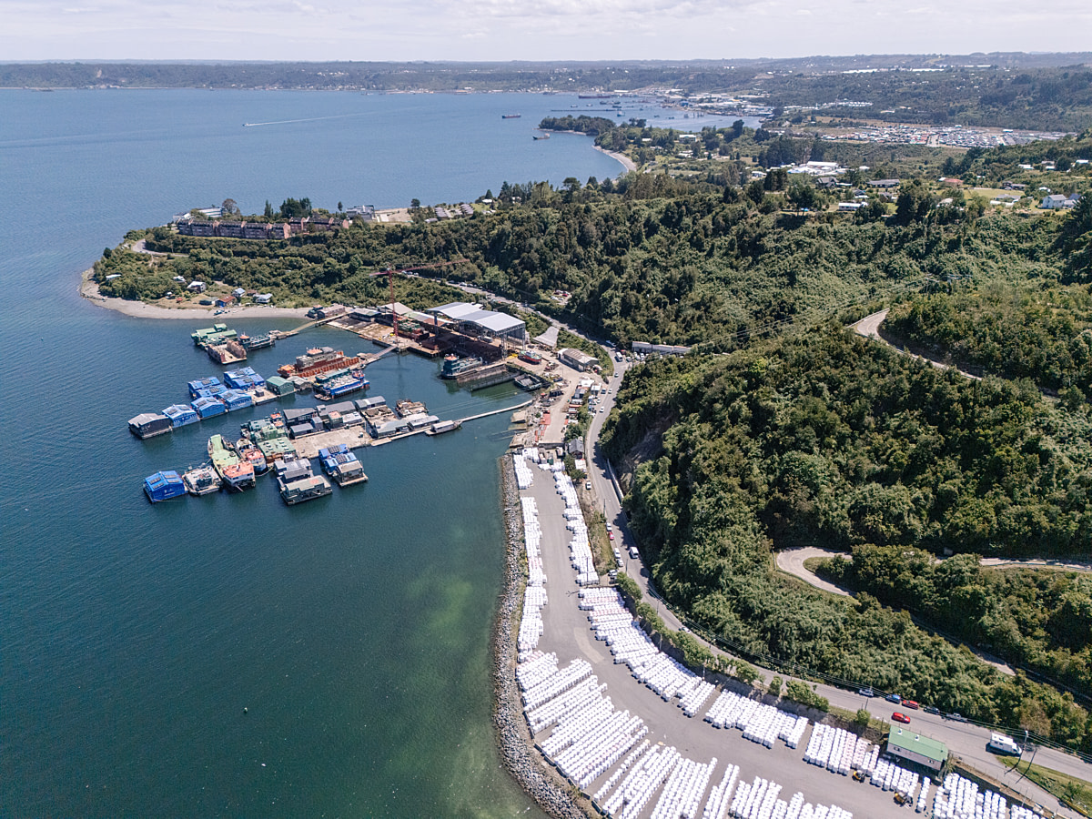 An aerial view of net cages, a floating work structure and other equipment at a salmon farm site in an estuary popular as an ecotourism destination. Undisclosed location, Cochamo, Llanquihue Province, Chile, 2025. Marcos Zegers / We Animals