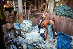 In Hazaribagh, a part of western Dhaka reknowned for its tanneries, several workers scrape the chemicaly dissolved fatty layers from the hides with specially designed knives.