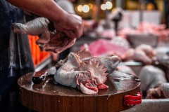 Newly-slaughtered chickens are chopped for sale at a wet market in Taipei. Taiwan, 2019.