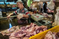 Pig skins are torched to remove hair at a meat stall in a Tapiei wet market. Taiwan, 2019.