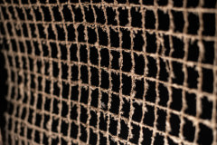 Dusty and dirt accumulates on the mesh covering the open spaces that offer ventilation.