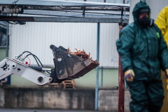 Masses of dead hens lie piled inside the bucket of a loader outside the barns of an egg farm near Prague in Czechia. The hens have been killed and workers wearing protective suits are in the process of removing them from the farm due to an outbreak of the H5N1 bird flu virus. Czechia, 2021. Lukas Vincour / Zvířata Nejíme / We Animals