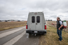 A local plumber disinfects his truck before entering a farm where poultry is raised. Disinfecting is required in control zones where the highly pathogenic H5N1 avian flu is identified. Canada, 2022. Jo-Anne McArthur / We Animals