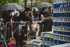 A worker hands a struggling chicken to a practitioner for use in the Kaporos ritual. USA, 2022. Victoria de Martigny / We Animals