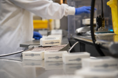 A worker at Miyoko's Creamery examines freshly packaged cultured vegan butter as it moves through the production process.