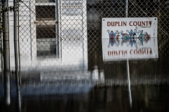 Partially submerged street sign in flood waters in North Carolina