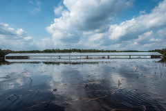 Industrial farm surrounded by flood water.