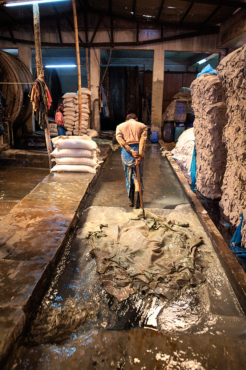 A worker drags several water-soaked hides behind him at a tannery in Hazaribagh, Dhaka.