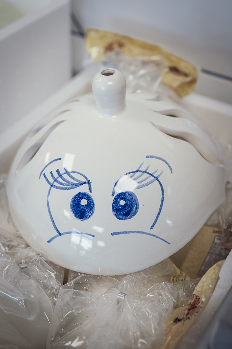 A food holder shaped like "La Zizzona," the dairy's signature buffalo mozzarella brand, sits on top of packaged cheeses at its shop and production facility. "Zizzona" is Campanian dialect for "large breast." La Zizzona Dairy, Battipaglia, Salerno, Italy, 2024. Raffaele Petralla / We Animals A food holder shaped like "La Zizzona," the dairy's signature buffalo mozzarella brand, sits on top of packaged cheeses at its shop and production facility. "Zizzona" is Campanian dialect for "large breast." La Zizzona Dairy, Battipaglia, Salerno, Italy, 2024. Raffaele Petralla / We Animals