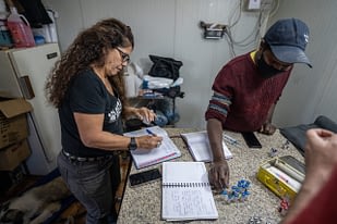 Helena Hesayne from Beirut Ethical Treatment for Animals writes down information about the dogs they are neutering at the BETA shelter in Lebanon.