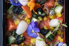Cultivated salmon, created by WildType, in a dish of rice, vegetables and flowers, by a Chef Jun Sog.