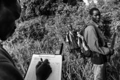 Ex-hunters trace their steps using GPS deep into Budongo Forest. Uganda, 2009.