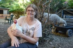 Patty Mark with rescued animals at her home. Australia, 2013.