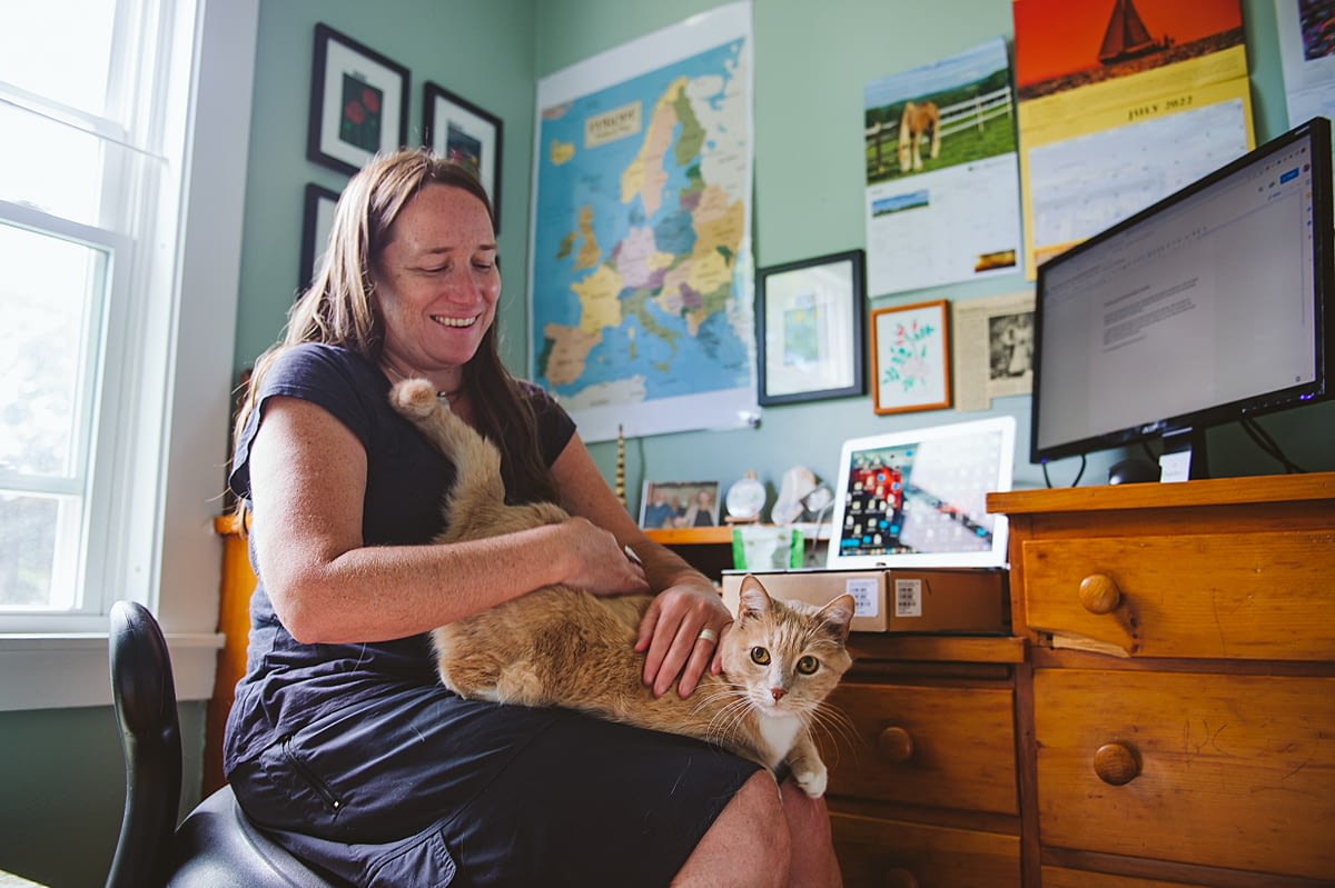 Grantwriter Hannah Murray enjoys a little cuddle time with rescue cat Tomasito in her home office. Photo by Victoria de Martigny / #unboundproject / We Animals Media