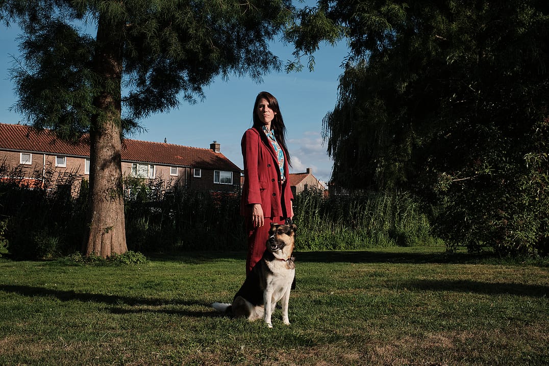 Eva Meijer poses with her companion Doris, a dog rescued from Romania who now lives with her. North Holland, Netherlands. 2022. Sabina Diethelm / #unboundproject / We Animals Media