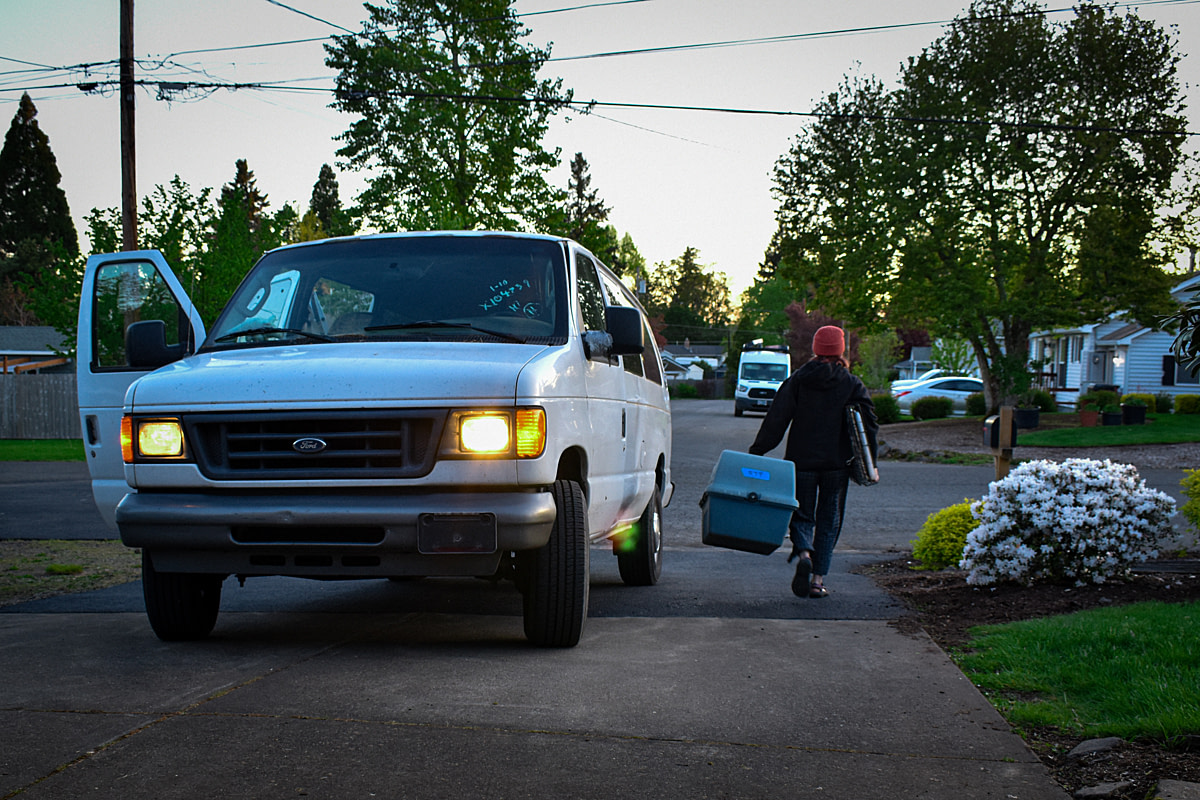 Rescuer Avery Laing carries crates to a van in the early morning on the first day of rescuing laying hens from a cage-free, organic farm. Oregon, USA, 2024. Diana Hulet / We Animals Media