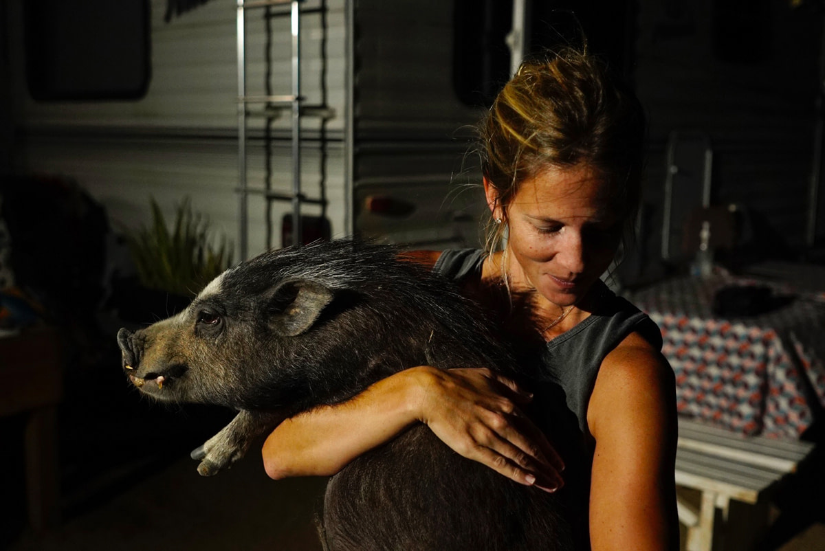 Photographer Molly Condit with a rescued pig. Photo credit: Thomas Machowicz