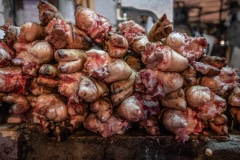 Severed pigs' feet torched and piled for sale at a wet market in Taipei. Taiwan, 2019.