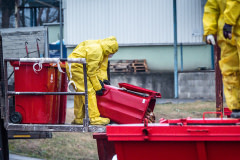 Dead hens are dumped on the ground from a garbage container outside the barns at an egg farm near Prague in Czechia. Workers wearing protective suits are killing and removing the hens from this farm due to an outbreak of the H5N1 bird flu virus there. Czechia, 2021. Lukas Vincour / Zvířata Nejíme / We Animals Media