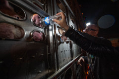 Gary Smith giving water to thirsty pigs at an LA Animal Save vigil.