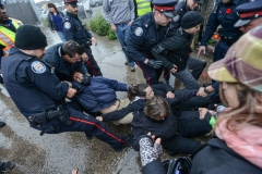 Police break up a peaceful protest outside a slaughterhouse. Canada, 2014.