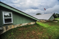 This stretch of small, dark buildings hold 2000 alligators. Louisiana, USA, 2010.