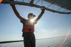 A Tri-State wildlife volunteer on one of the search and rescue boats, looking for injured animals. USA, 2010.