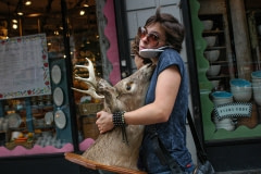 Woman with a mounted deer head. USA, 2005.