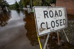 Road Closed sign at the edge of the floodwater in Fair Bluff after Hurricane Florence. North Carolina, USA.