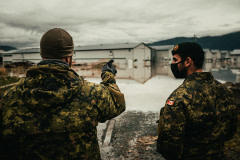 Two members of the Canadian military discuss plans for how to move more than 10,000 chickens from one barn to another during a devastating flood in Abbotsford, BC. Canada, 2021. Nick Schafer Media / We Animals Media