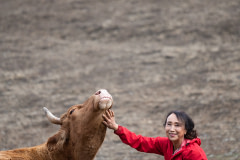 Miyoko Schinner, founder of Miyoko's Creamery, making friends at a farm animal sanctuary.