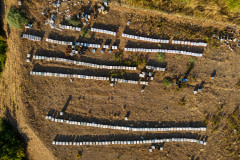 Aerial view of rows of honey production bee hives set up in a mountainside apiary. Bees require close access to forest areas to meet their nutritional needs. Kozluk, Batman, Batman Province, Southeastern Anatolia Region, Turkiye, 2023. Havva Zorlu / We Animals Media