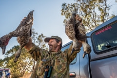 A duck hunter displays his kill. Australia, 2017.