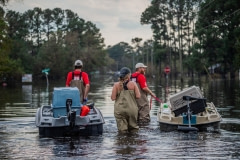 Local activists from Brother Wolf, survey the flooding in the town of Wallace. North Carolina, USA.