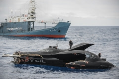 The Ady Gil, broken but still afloat, after being rammed by the Shonan Maru II, in the background. Antarctic Ocean, 2010.