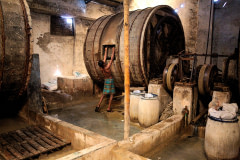 A worker closes a large barrel filled with hides and chemicals, used for the tanning process at a tannery in Hazaribagh, Dhaka.