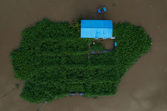 An aerial view of an abandoned floating pen at a river in Thailand. As more fish farms are affected by the economy,  a growing number of small farms are closing down.