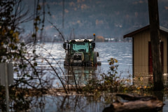 A tractor sits partially submerged in water during the 2021 Abbotsford, BC flooding.