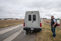 A local plumber disinfects his truck before entering a farm where poultry is raised. Disinfecting is required in control zones where the highly pathogenic H5N1 avian flu is identified. Canada, 2022. Jo-Anne McArthur / We Animals Media
