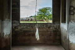 A frayed plastic sack hangs above a recently cleaned bare concrete pig pen. Such sacks are considered a form of enrichment for the animals' welfare.