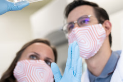 TurtleTree's Vanessa Castagna and Ignacio Vargas examining a tray of cell cultures.