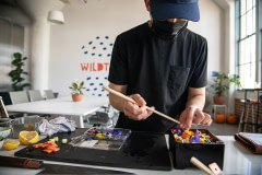 Sushi chef Jun Sog plates Wildtype's cell-cultivated salmon and other ingredients in their test kitchen in San Francisco.