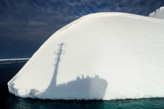 The shadow of the Bob Barker against an iceberg.