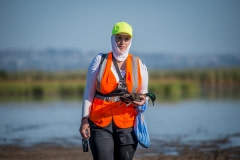 A vvolunteer holds a dead duck on opening day of duck hunting season. Australia, 2017.