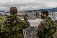 Two members of the Canadian military discuss plans for how to move more than 10,000 chickens from one barn to another during a devastating flood in Abbotsford, BC.