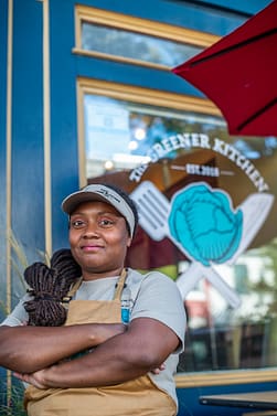 Vegan advocate, humanitarian, and entrepreneur Brenda Sanders stands outside her vegan restaurant in Baltimore, The Greener Kitchen. Photo by: Jo-Anne McArthur / #UnboundProject / We Animals Media.