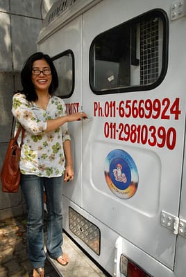 Dr. Sarungbam Yaiphabi Devi with one of the Animal India Trust mobile vet clinic vehicles.